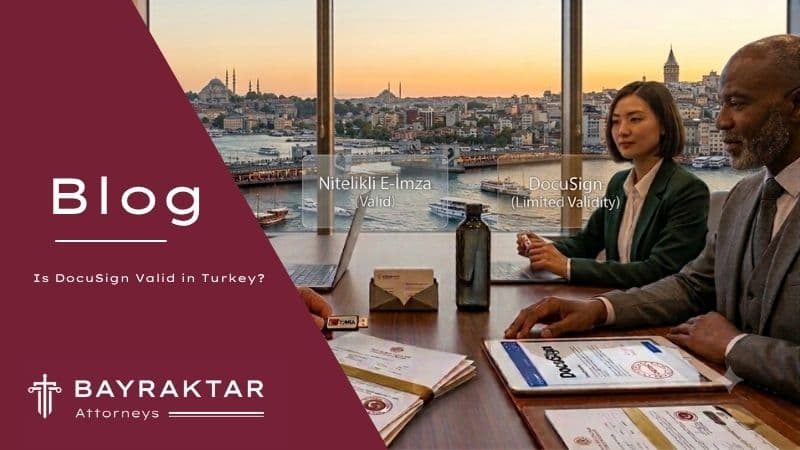Two professionals reviewing DocuSign and Turkish qualified e-signature documents at a meeting table with Istanbul Bosphorus view in the background