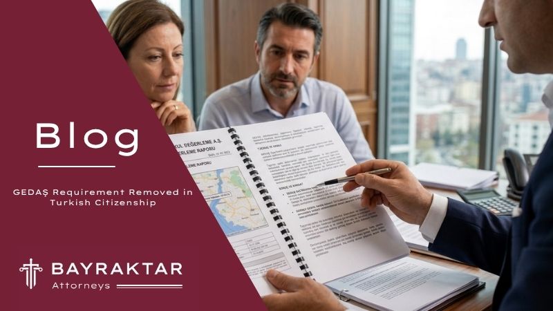 Two clients reviewing a GEDAŞ real estate valuation report with their Bayraktar Attorneys lawyer in an Istanbul office overlooking the city